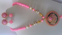 metal and glass neckless with pink pendant and earings