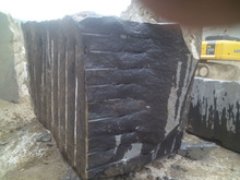 Chiselled black granite rough block