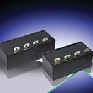Capacitors with sheet metal connectors