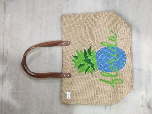 Jute bag with brown rexine handle.