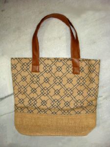 Jute bag with brown rexine handle..