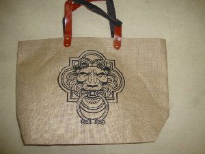 Jute bag with rexine handle.