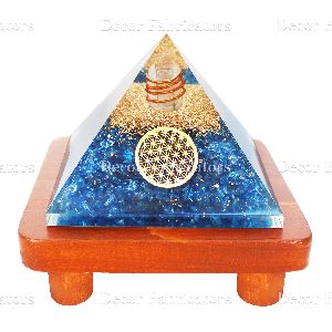 Orgone Blue Crystal Stone Vastu Pyramid with Round Healing Symbol On a Brown Wooden Stand