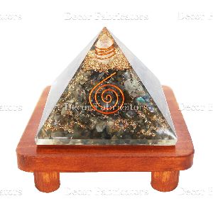 Orgone Labradorite Stone Vastu Pyramid with Round Spring Symbol On a Brown Wooden Stand