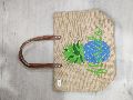 Jute bag with brown rexine handle .