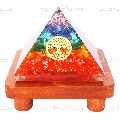 7 Chakra Stone Orgone Vastu Pyramid With Golden Round Fengshui Symbol And Brown Wooden Stand