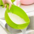 Green plastic rice strainer bowl